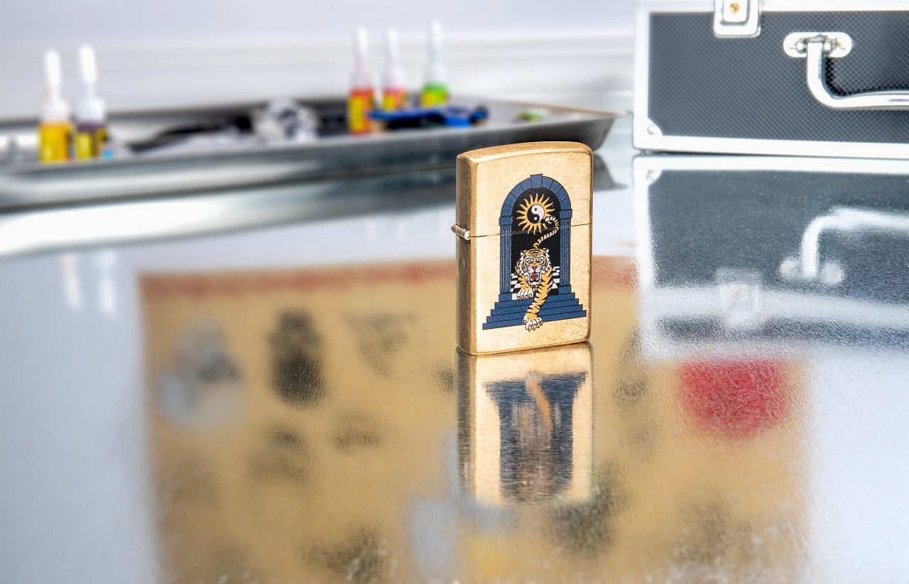 Front shot of Zippo Bejeweled Beetle Design High Polish Brass Windproof Lighter standing at a 3/4 angle.